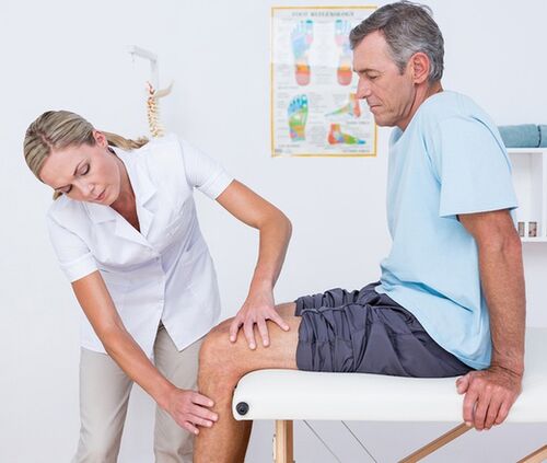 The doctor conducts a visual examination and palpation of the patient with knee pain
